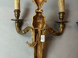 a wall mounted candle holder with three candles on it