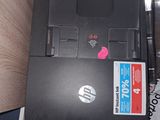 a black laptop sitting on top of a pile of papers
