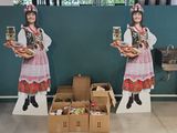 two cardboard figures of a woman holding a box of food