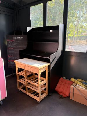 a piano in the corner of a room with boxes on the floor