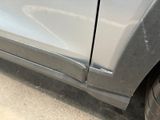 a close up of a car with a denting on the side of it