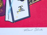 a picture of a picture of a chanel bag on a red background