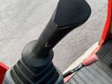 a close up of a red and black steering control on a scooter