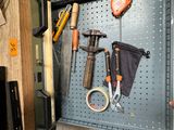 many tools hanging on the wall in the garage