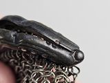 a person holding a chainmail in their hand