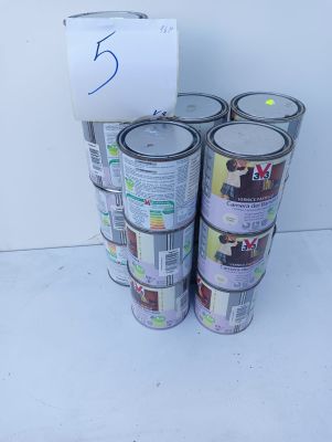several cans of paint are stacked on top of each other