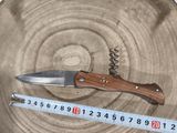 a knife that is sitting on top of a piece of wood
