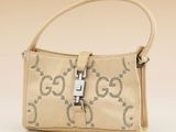 beige guccissi handbag with silver hardware on strap