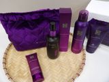 the contents of a purple bag are sitting on a table