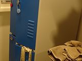 a blue locker in the corner of a room
