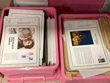 two pink boxes filled with books and papers