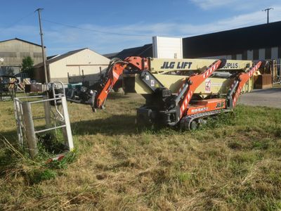 a small excavator that is parked in the grass