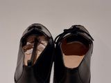 black leather shoes on a white surface with a white background