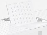 a white table with two chairs on it in front of a white wall
