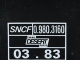 a close up of a sticker on a black dumpster