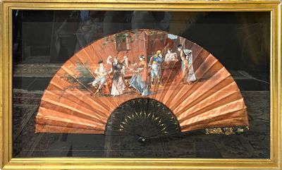 une photo d'un tableau représentant un éventail, dans un cadre doré