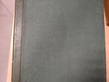 a green book sitting on top of a wooden table