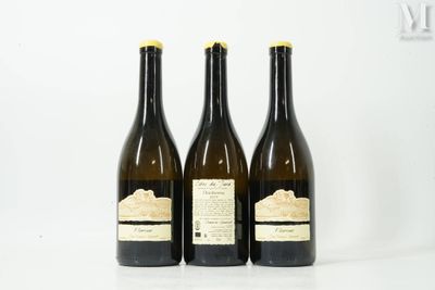 three bottles of wine sitting on top of a white table
