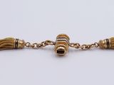 a close up of a gold bracelet with tassels on it
