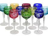 several different colored wine glasses are lined up in a row