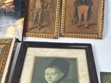 many framed pictures of women and men on the wall