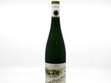 a bottle of wine sitting on top of a white table