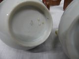 a white bowl and a white bowl sitting on a table