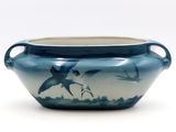 a blue vase with a picture of birds on it