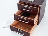 three drawers that are open on a white surface