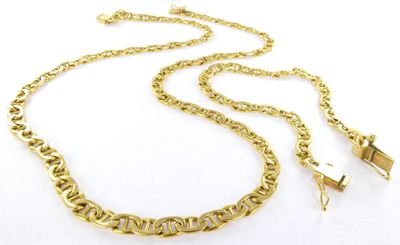 a close up of a gold chain necklace on a white background