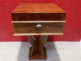 a small wooden table with a drawer on top of it