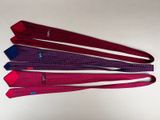 six ties of different colors are arranged on a white surface