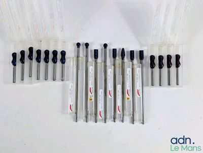 several different types of pens are lined up on a white surface