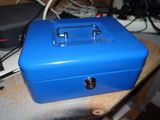 a blue metal box sitting on top of a table