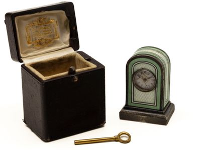 a small box with a clock and a key in it