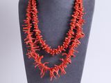 a red coral necklace on a mannequin display on a mannequin
