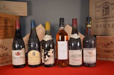 several bottles of wine are lined up on a red table