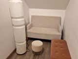 a room with a couch, a chair, and a lamp in it