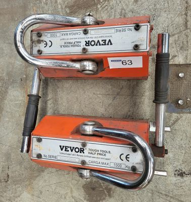 Deux leviers orange et argentés reposent sur une surface en béton