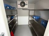 an image of a kitchen with stainless steel shelves and a fan