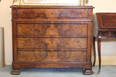une commode surmontée d'un miroir, à côté d'une petite table