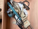 a box with a drill and other tools inside of it