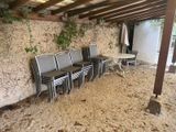 many chairs and tables under a covered patio