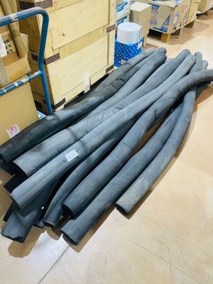 a lot of pipes sitting on the floor in a warehouse