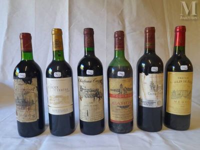 six bottles of wine are lined up in a row on a table