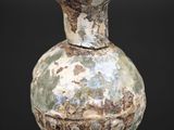 a vase that is sitting on a black surface