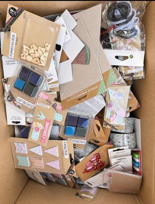 a cardboard box full of assorted items in it