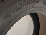 someone is holding a tire that has been painted black and has writing on it