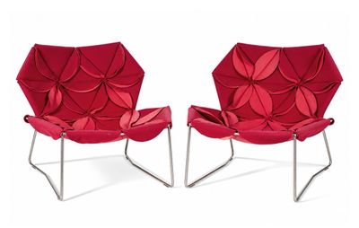 pair of red modern lounge chairs on chrome steel legs