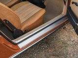 a car with the door open and the seat up